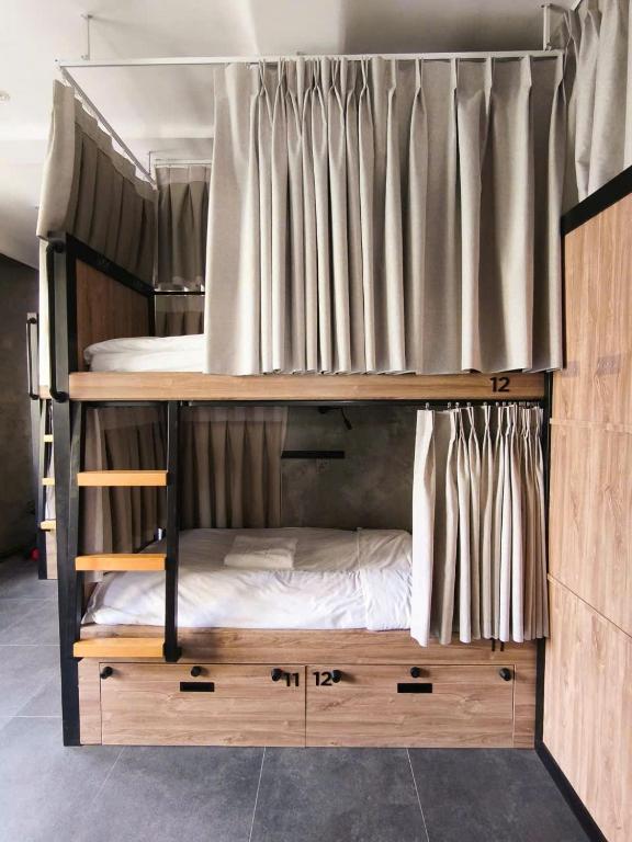 Modern hostel pod beds with privacy curtains